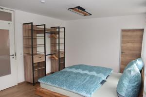 a bedroom with a bed and a book shelf at Ferienwohnung Eder in Bad Birnbach