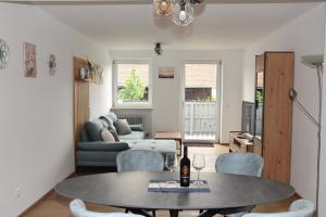 a living room with a table and chairs and a couch at Ferienwohnung Eder in Bad Birnbach