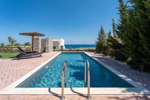 a swimming pool in the backyard of a villa at Heliophos Villa Amalthia in Kiotari