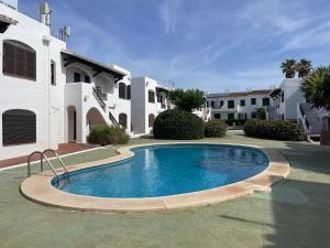 a swimming pool in front of a house at ELS VENTS 26 by SOM Menorca in Son Parc