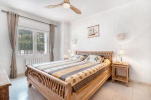 a bedroom with a bed and a window at Villa Jeannine in El Tosalet +17 photos