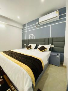 a bedroom with a large bed with yellow and black sheets at KingRama Hotel in Orchha +140 photos
