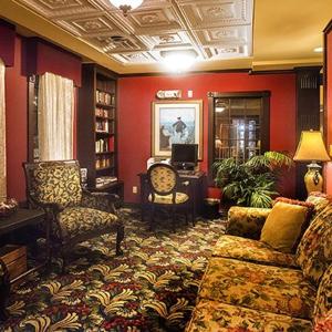 a living room with a couch and a table and chairs at Lighthouse Inn at Aransas Bay in Rockport