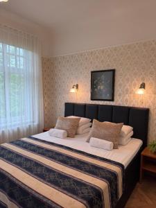 a bedroom with a large bed with two pillows at Green Villa in Pärnu