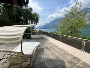 a chair on a patio with a view of a lake at Large vacation home with mountain views in Quarten