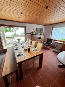 a dining room with a wooden table and chairs at Large vacation home with mountain views in Quarten