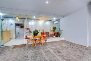 a dining room with a table and chairs in a room at Hotel O Tegal near near Pacific Mall Tegal formerly Hugo Suites Family in Tegal