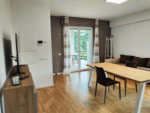 a living room with a table and a couch at Bastia Home Plus in Bastia Umbra