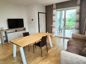 a living room with a wooden table and a couch at Bastia Home Plus in Bastia Umbra