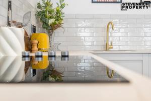 a kitchen counter with a sink and a yellow faucet at NEW High End Central Apartment 2 Bedrooms 6 Guests in Brighton & Hove