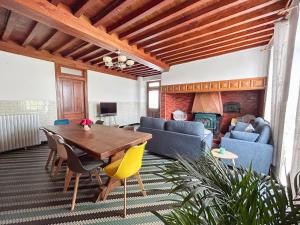 a living room with a table and a fireplace at Séjour champêtre à la ferme près de Pau in La Celle-sous-Gouzon