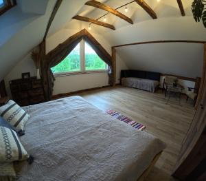 a bedroom with a large bed in a attic at Miejski Las 8 in Mrągowo +74 photos