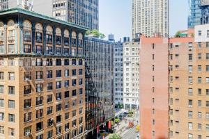 an aerial view of a city with tall buildings at Blueground Midtown West wd nr Broadway NYC-1863 in New York