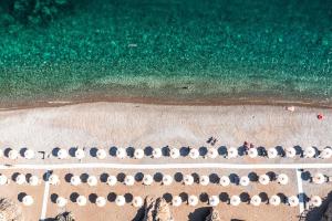 an overhead view of a beach with umbrellas and the ocean at The Chedi Luštica Bay in Tivat