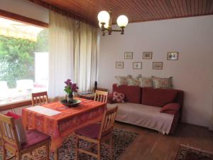 a living room with a couch and a table with chairs at Holiday home in Balatonfüred 18777 in Balatonfüred