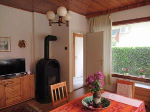 a living room with a wood stove and a table at Holiday home in Balatonfüred 18777 in Balatonfüred