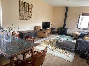a living room with a table and a couch at Villa Doble M in Cervera de Pisuerga