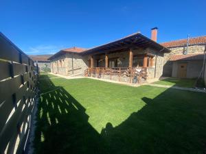 a house with a large yard with a fence at Villa Doble M in Cervera de Pisuerga