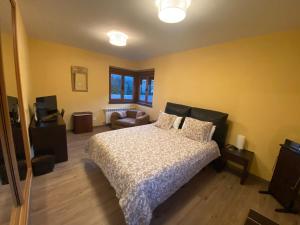 a bedroom with a bed and a living room at Villa Doble M in Cervera de Pisuerga +15 photos