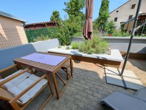 a patio with a table and an umbrella at Federica A2+1 in Veli Lošinj