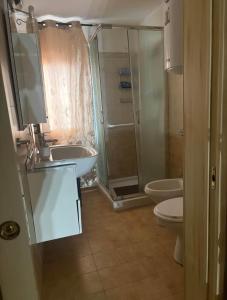 a bathroom with a shower and a sink and a toilet at la maison de agata in Catania