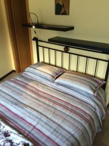 A bed or beds in a room at La Perla del Lago di Como - CIR O97O67