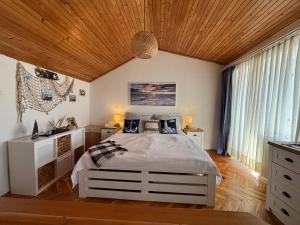 a bedroom with a bed and a wooden ceiling at Apartmán Stašica in Selce