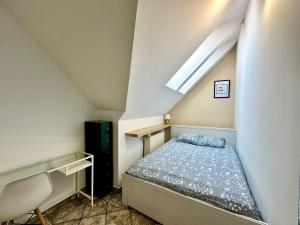 a small bedroom with a bed in a attic at Pokoje Monte 49 in Sopot