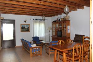 a dining room with a wooden table and chairs at Casa Rural El Alfar in Tajueco