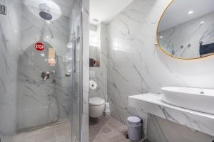 a bathroom with a sink and a toilet and a mirror at Sofia's Villa in Nikiti +47 photos
