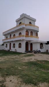 a large white building with a lot of windows at KAPOOR SAHAB HOMESTAY COUNTRYSIDE Its a home away from home in Saraia