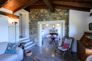 a living room with a couch and a stone wall at Villa Gia in Someraro