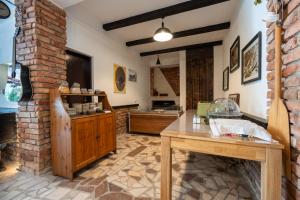 a kitchen with a table and a brick wall at Villa Piccolotti in Neum