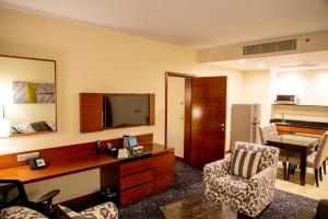 a living room with a desk and a television at Hilton Garden Inn Nairobi Airport in Nairobi
