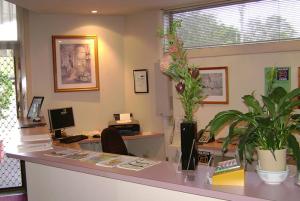 an office with a desk with a computer and plants at River Park Motor Inn in Casino