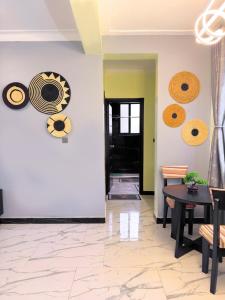 a room with a table and plates on the wall at Arana Royal Homes in Kampala