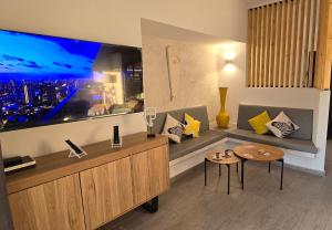 a living room with a large flat screen tv at El Bungalow in Playa Fañabe