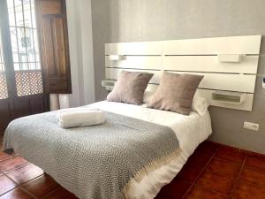 Postel nebo postele na pokoji v ubytování RIBERA SUITE CÓRDOBA