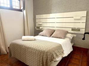Postel nebo postele na pokoji v ubytování RIBERA SUITE CÓRDOBA