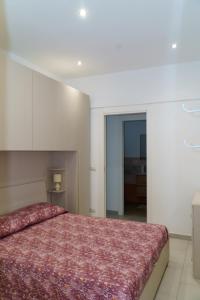 a bedroom with a large bed with a red blanket at Boulevard Holiday in Avola