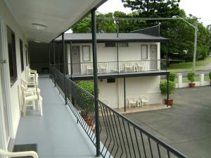 a balcony of a house with chairs and a porch at River Park Motor Inn in Casino