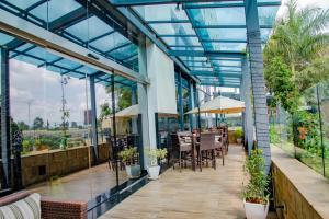 an outdoor patio with tables and chairs and windows at Hilton Garden Inn Nairobi Airport in Nairobi