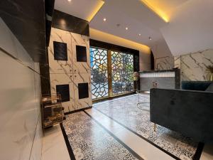 a living room with a couch and a table at Rich Hotel in Mumbai +8 photos