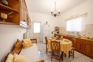 a kitchen with a table and a dining room at Amoni House- An authentic village stay in Pyrgos
