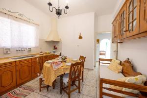 a kitchen with a table and a dining room at Amoni House- An authentic village stay in Pyrgos +9 photos