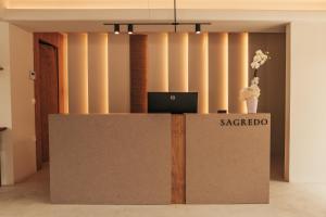 a reception desk with a laptop on top of it at Sagredo Boutique Hotel & Spa in Ágios Fokás