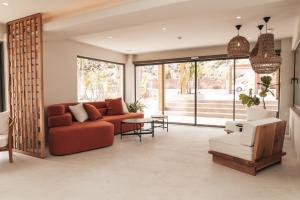 a living room with a red couch and a table at Sagredo Boutique Hotel & Spa in Ágios Fokás