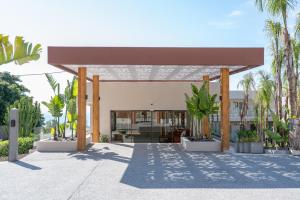 a building with palm trees in front of it at Sagredo Boutique Hotel & Spa in Ágios Fokás