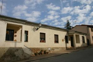 a white building on the side of a street at Casa Rural El Alfar in Tajueco