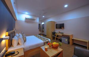 a hotel room with a bed and a desk at TreeHouse Morina, Vithalapur in Vithalpur